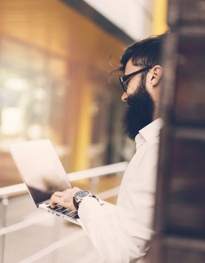 close-up-young-businessman-typing-laptop
